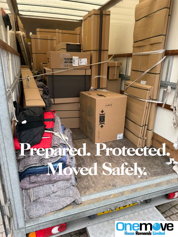 Professional movers loading furniture into a removal van for a UK house move
