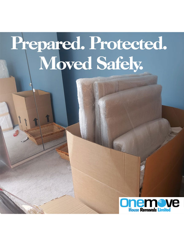 Professional movers loading furniture into a van for a UK man with a van move